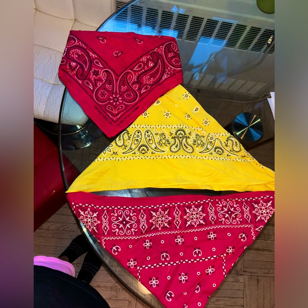 Three bandanas. Two red bandanas , 1 yellow bandana